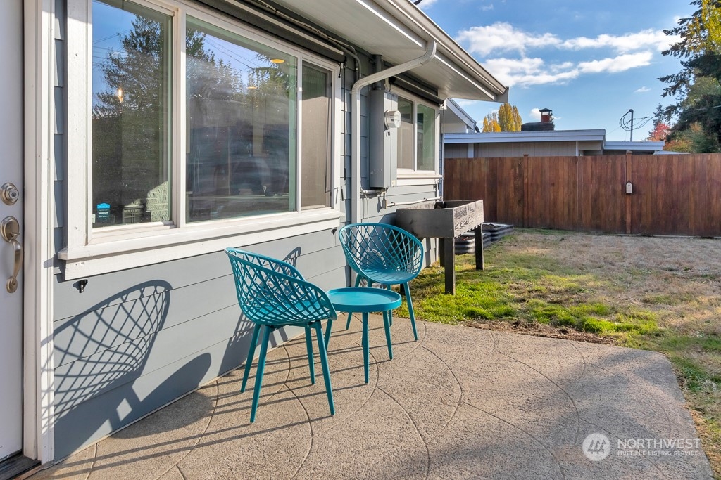 9203 29th Avenue Southwest Seattle, WA 98126 - Photo 21 of 25 a view of a patio with table and chairs and wooden fence