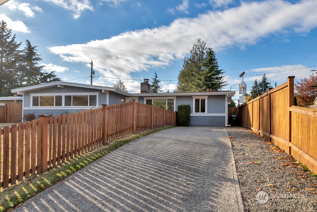 9203 29th Avenue Southwest Seattle, WA 98126 - Photo 24 of 25 a front view of a house with a yard and garage