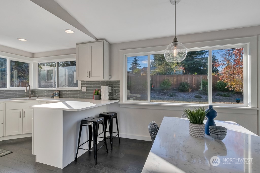 9203 29th Avenue Southwest Seattle, WA 98126 - Photo 6 of 25 a open kitchen with a table and chairs