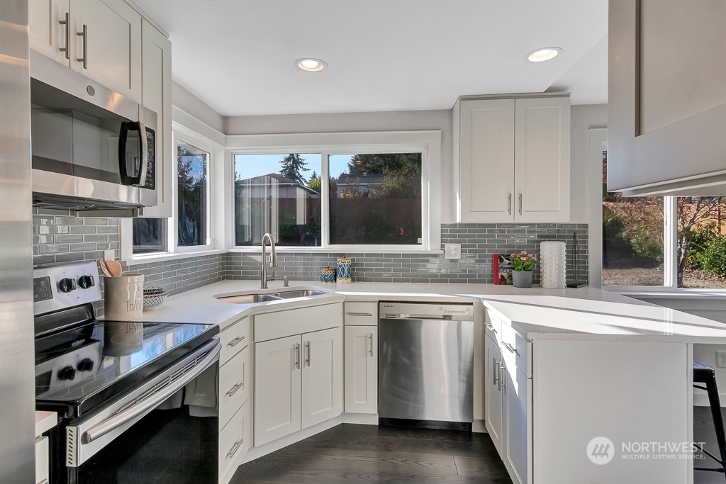 9203 29th Avenue Southwest Seattle, WA 98126 - Photo 7 of 25 a kitchen with a sink stove and microwave