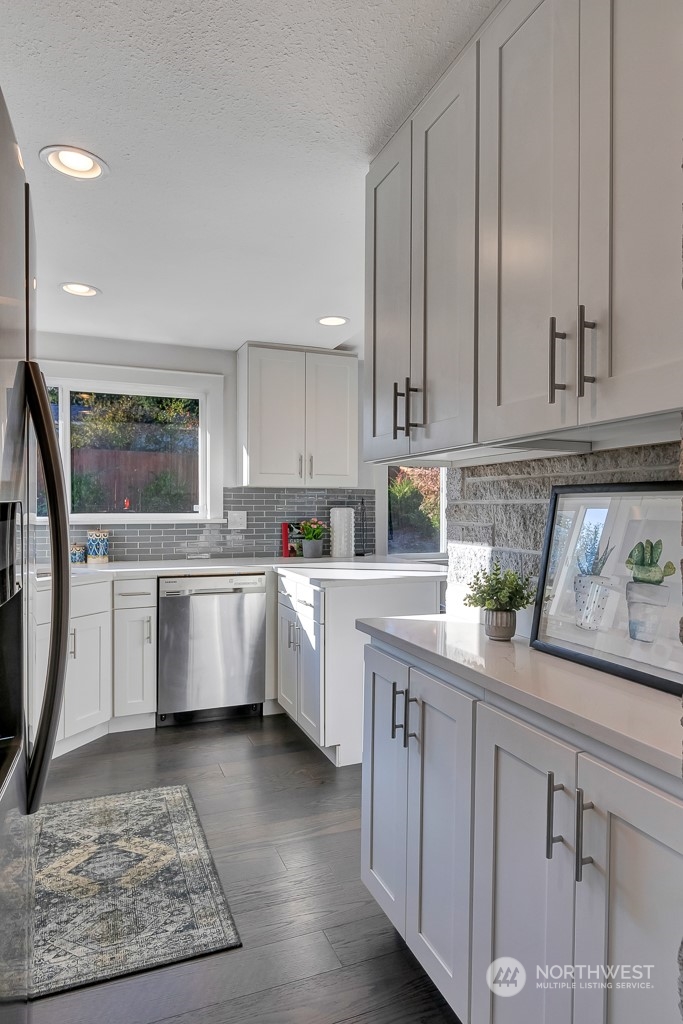 9203 29th Avenue Southwest Seattle, WA 98126 - Photo 9 of 25 a kitchen with granite countertop a sink stainless steel appliances and cabinets