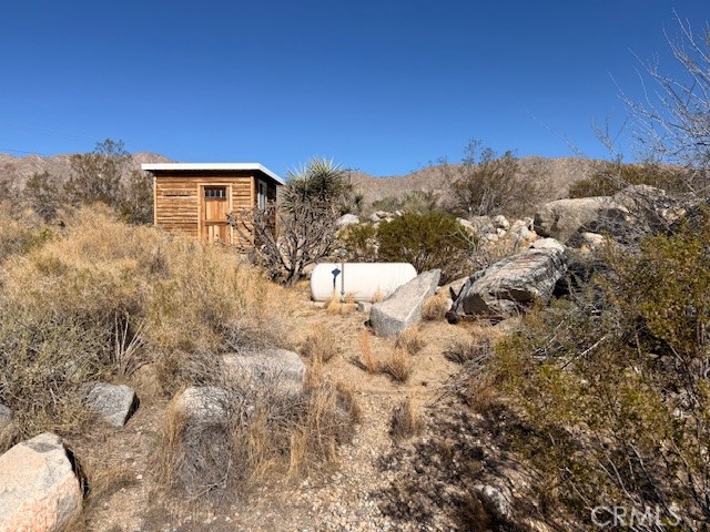 51136 Mecca Road Morongo Valley, CA 92256 - Photo 3 of 12 a view of a dry yard with trees