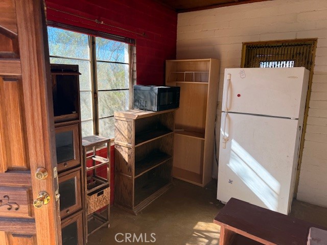 51136 Mecca Road Morongo Valley, CA 92256 - Photo 9 of 12 a white refrigerator freezer and a stove sitting inside of a kitchen