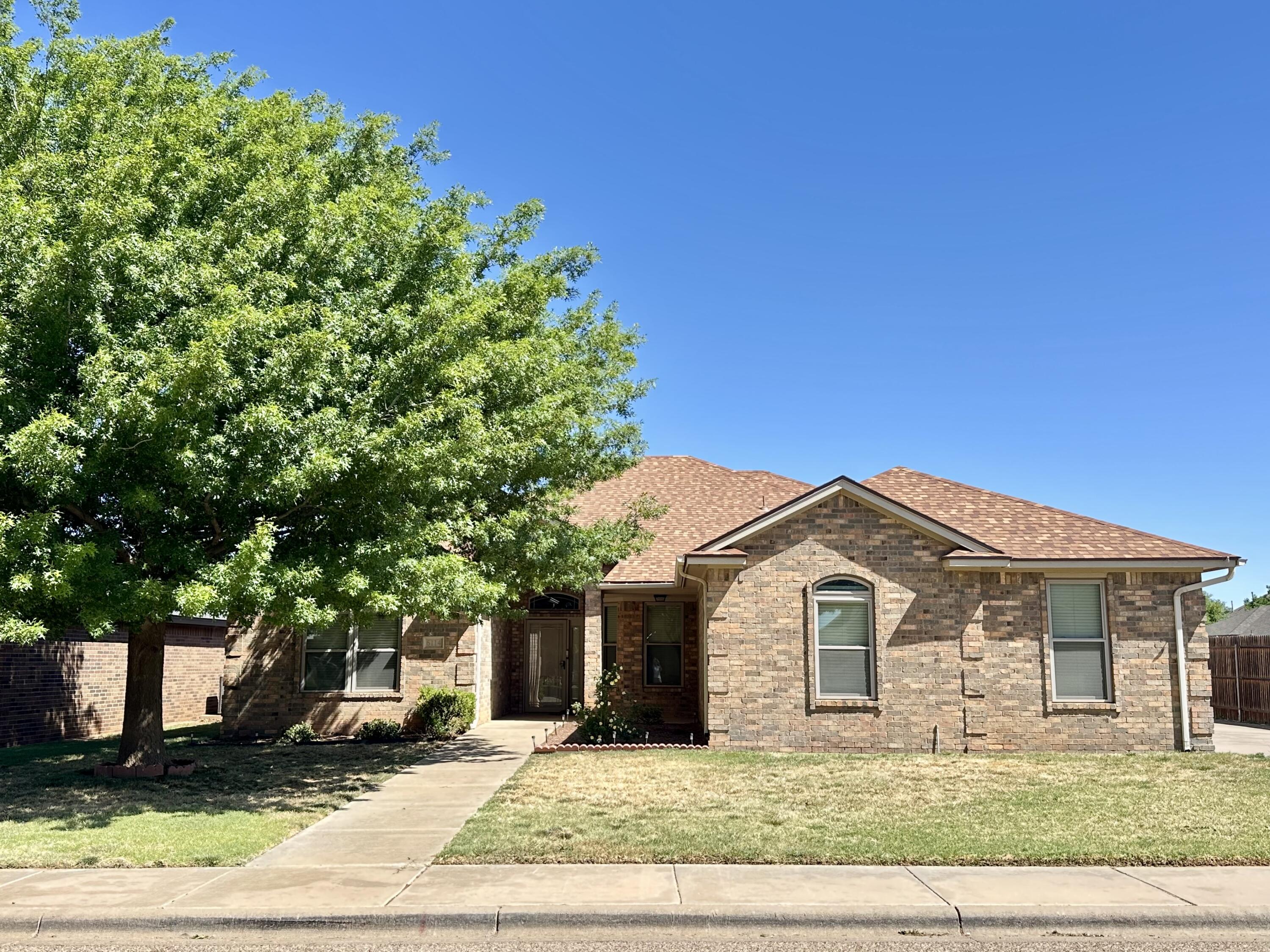 6114 75th Place Lubbock, TX 79424 - Photo 1 of 35 a front view of a house with a yard