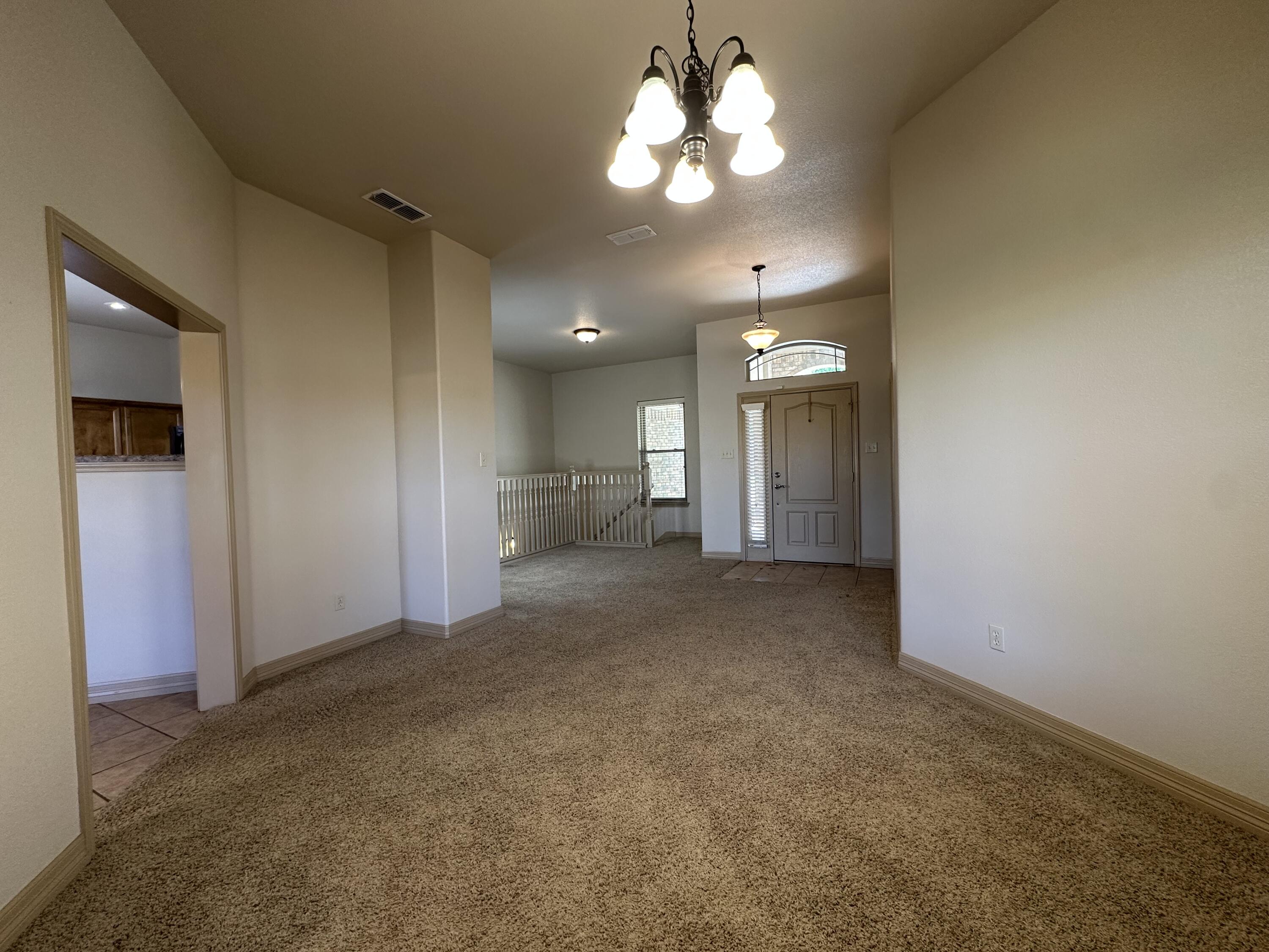 6114 75th Place Lubbock, TX 79424 - Photo 16 of 35 a view of a room with a chandelier fan and windows