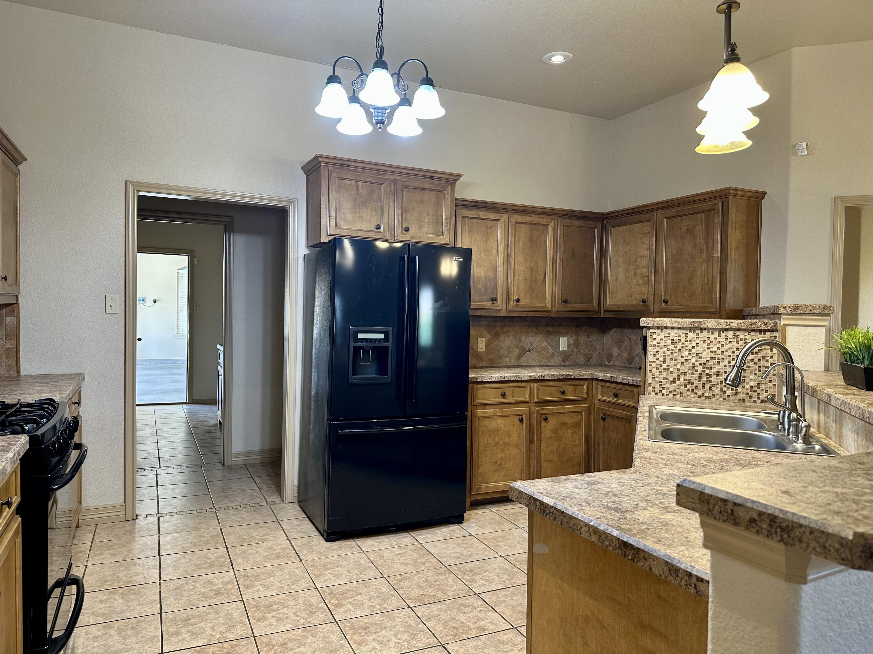 6114 75th Place Lubbock, TX 79424 - Photo 2 of 35 a kitchen with stainless steel appliances granite countertop a refrigerator and a sink