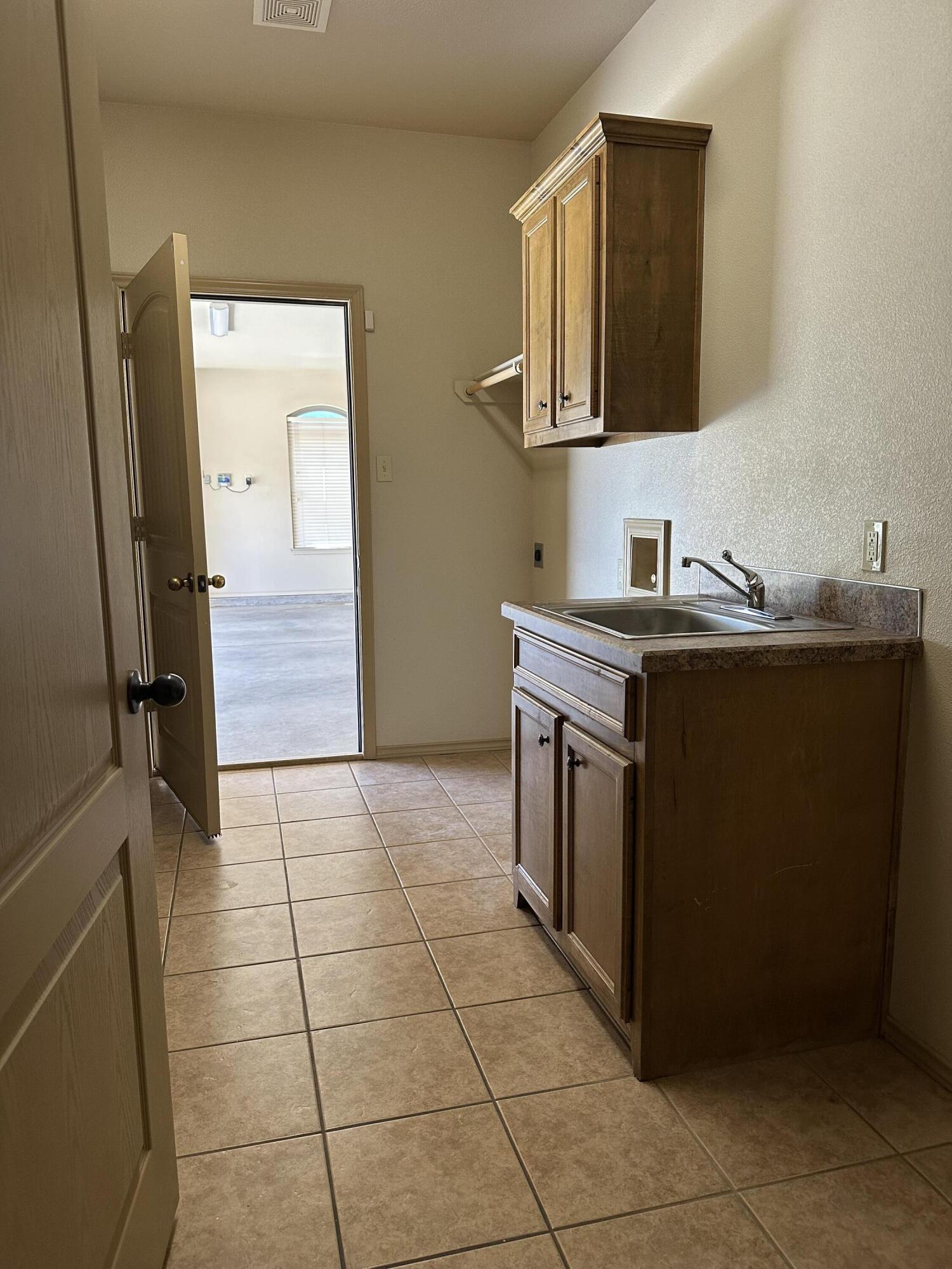6114 75th Place Lubbock, TX 79424 - Photo 26 of 35 a kitchen with stainless steel appliances a sink stove and refrigerator