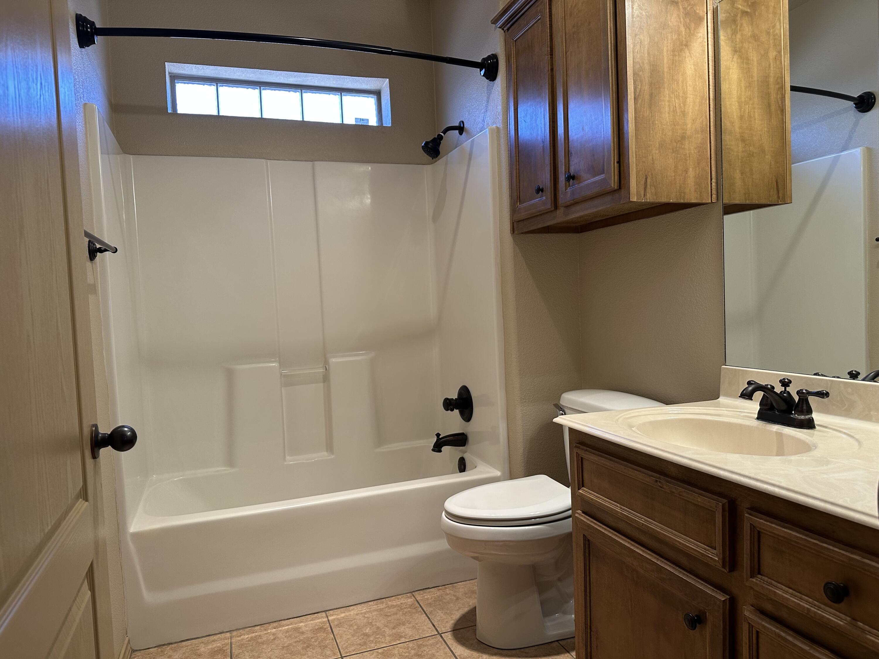 6114 75th Place Lubbock, TX 79424 - Photo 27 of 35 a bathroom with a sink a toilet and bathtub