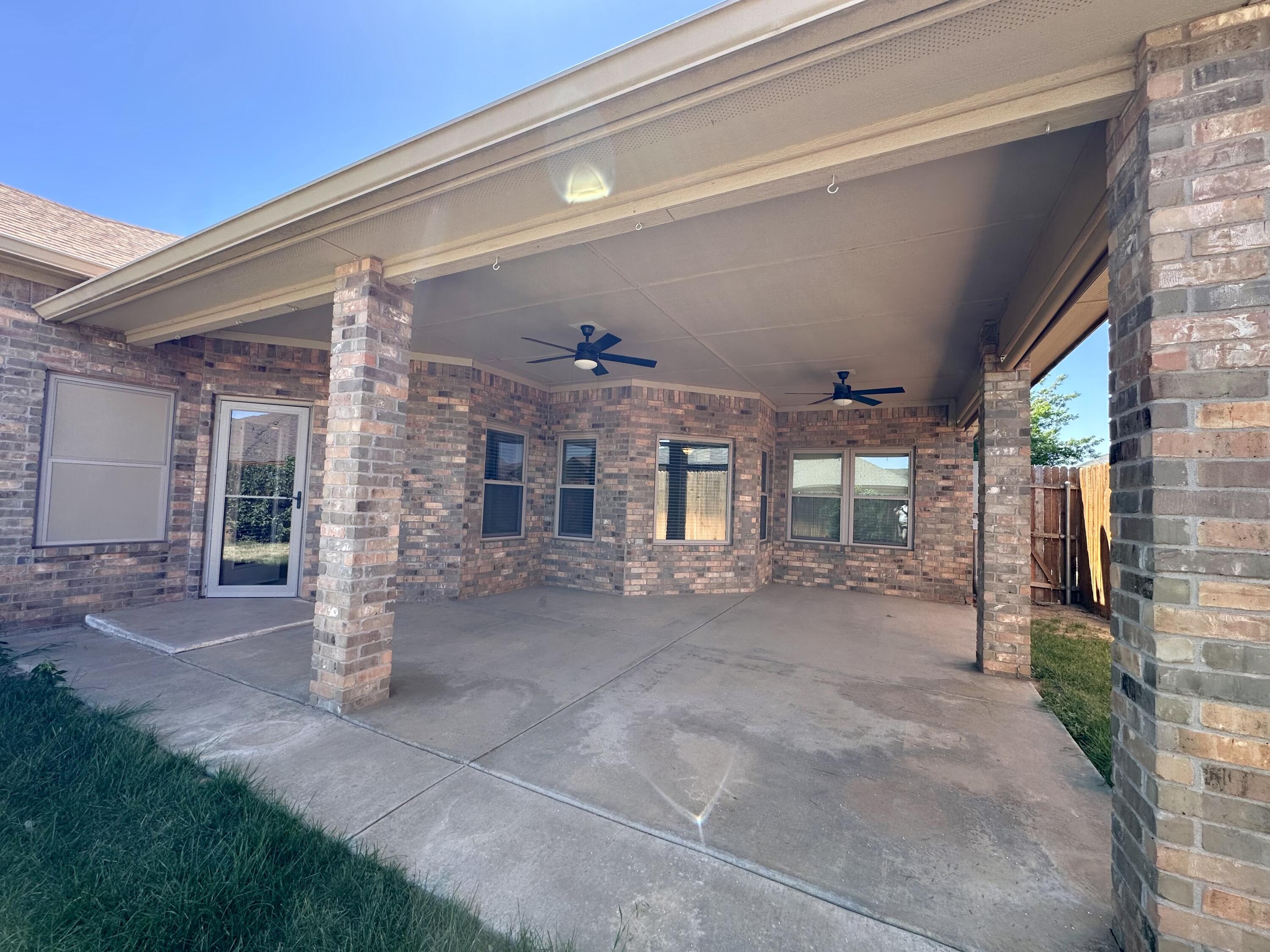 6114 75th Place Lubbock, TX 79424 - Photo 32 of 35 a view of a house with a patio and a yard