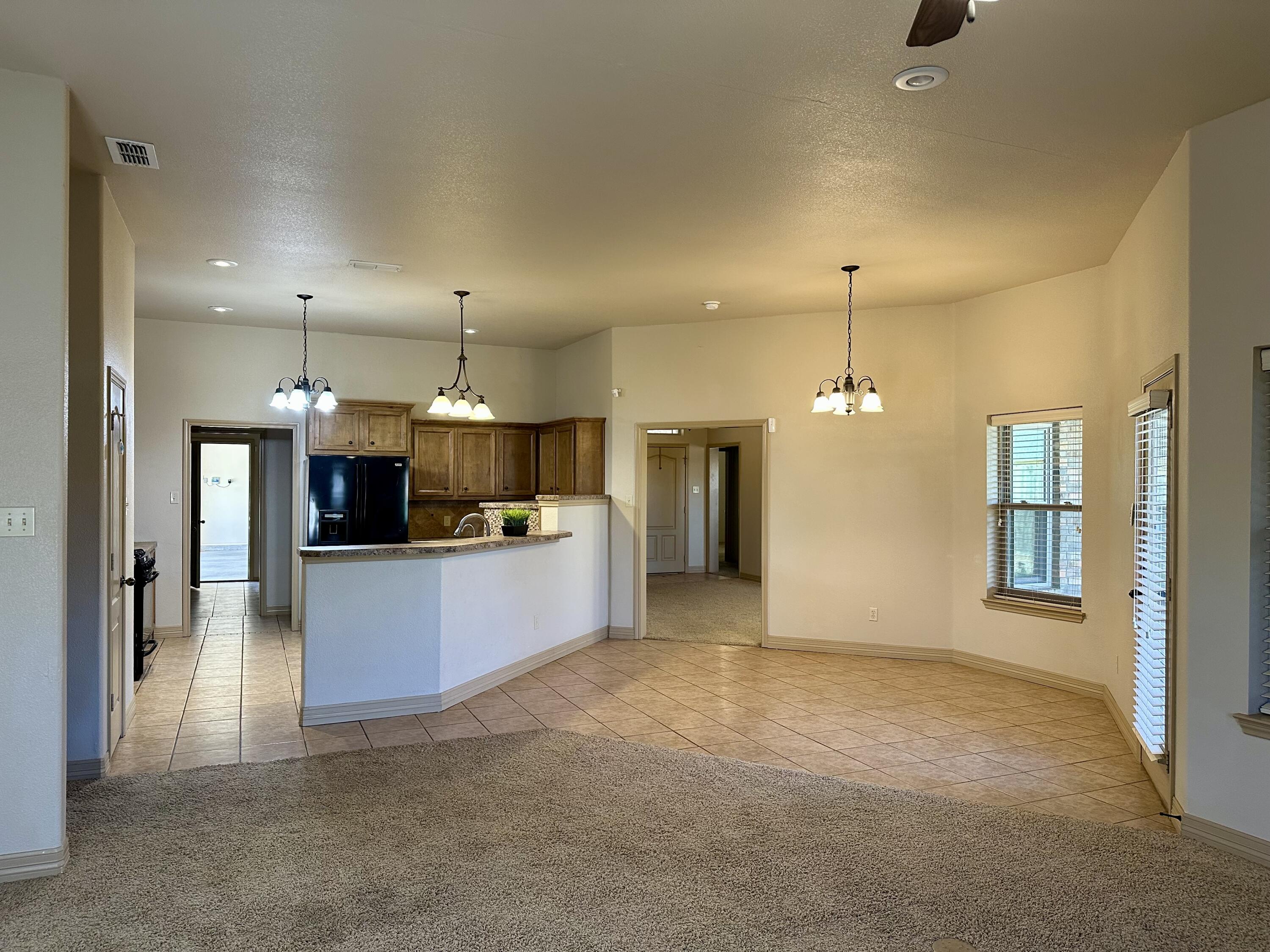6114 75th Place Lubbock, TX 79424 - Photo 6 of 35 a large kitchen with a refrigerator a oven and a sink