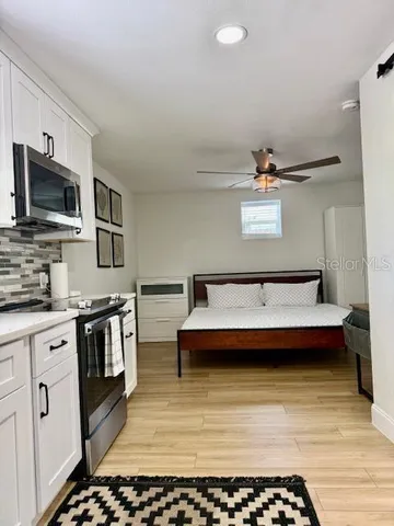 a kitchen with stainless steel appliances kitchen island granite countertop a sink and stove top oven