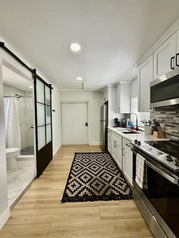 a kitchen with stainless steel appliances granite countertop a stove and a refrigerator