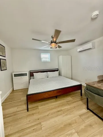 a bedroom with a bed and ceiling fan
