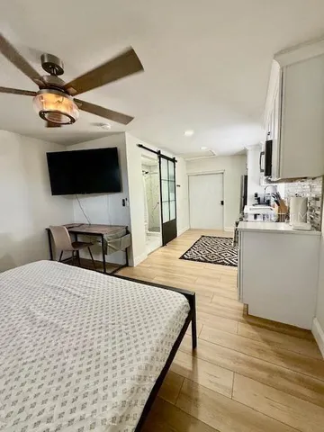 a bedroom with a bed and a flat screen tv