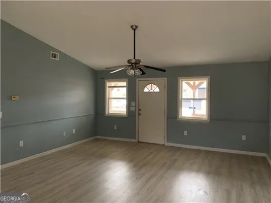 838 Racetrack Road Toccoa, GA 30577 - Photo 2 of 7 an empty room with wooden floor and windows