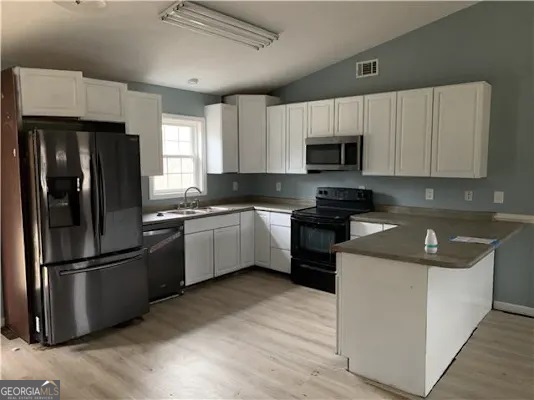 838 Racetrack Road Toccoa, GA 30577 - Photo 3 of 7 a kitchen with a refrigerator sink and cabinets