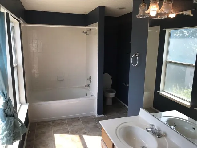 a bathroom with a bathtub and a sink