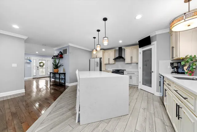a kitchen with stainless steel appliances a stove a sink and a refrigerator