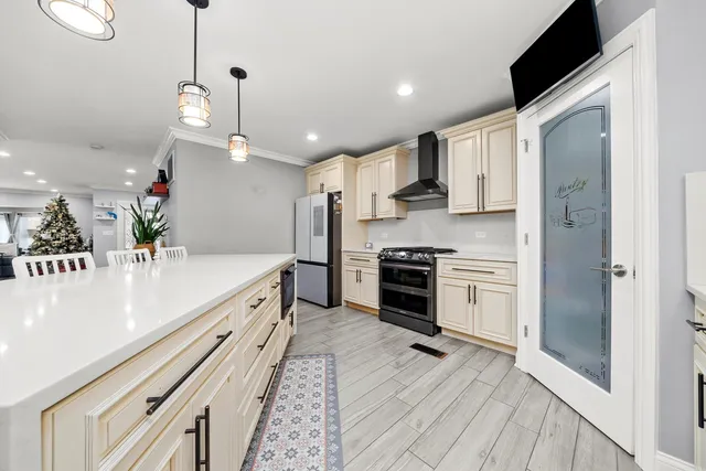 a kitchen with stainless steel appliances granite countertop a stove and a refrigerator