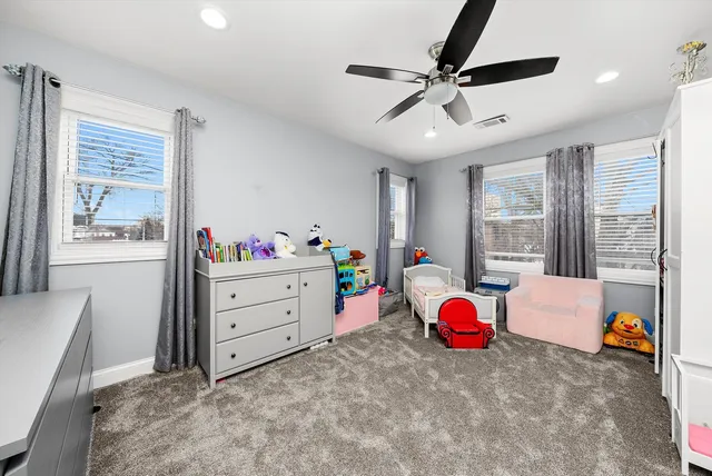 a children room with furniture and a flat screen tv