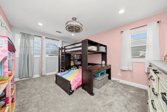 a bedroom with furniture and a chandelier