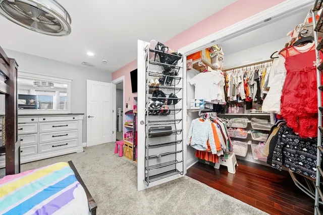 a bathroom with a granite countertop toilet sink and mirror