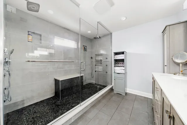 a bathroom with a sink a toilet and shower