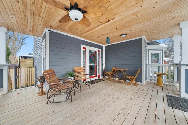 a view of a house with a small yard and wooden fence