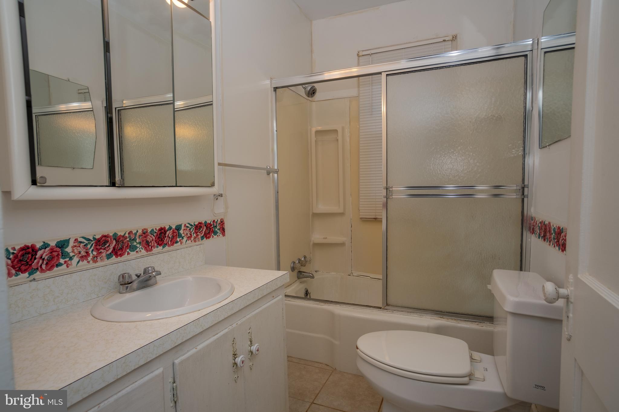 12401 Wright Avenue Cumberland, MD 21502 - Photo 13 of 17 a bathroom with a sink toilet and shower