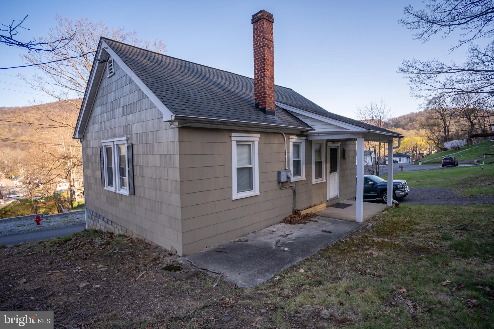 12401 Wright Avenue Cumberland, MD 21502 - Photo 3 of 17 a front view of a house with garden