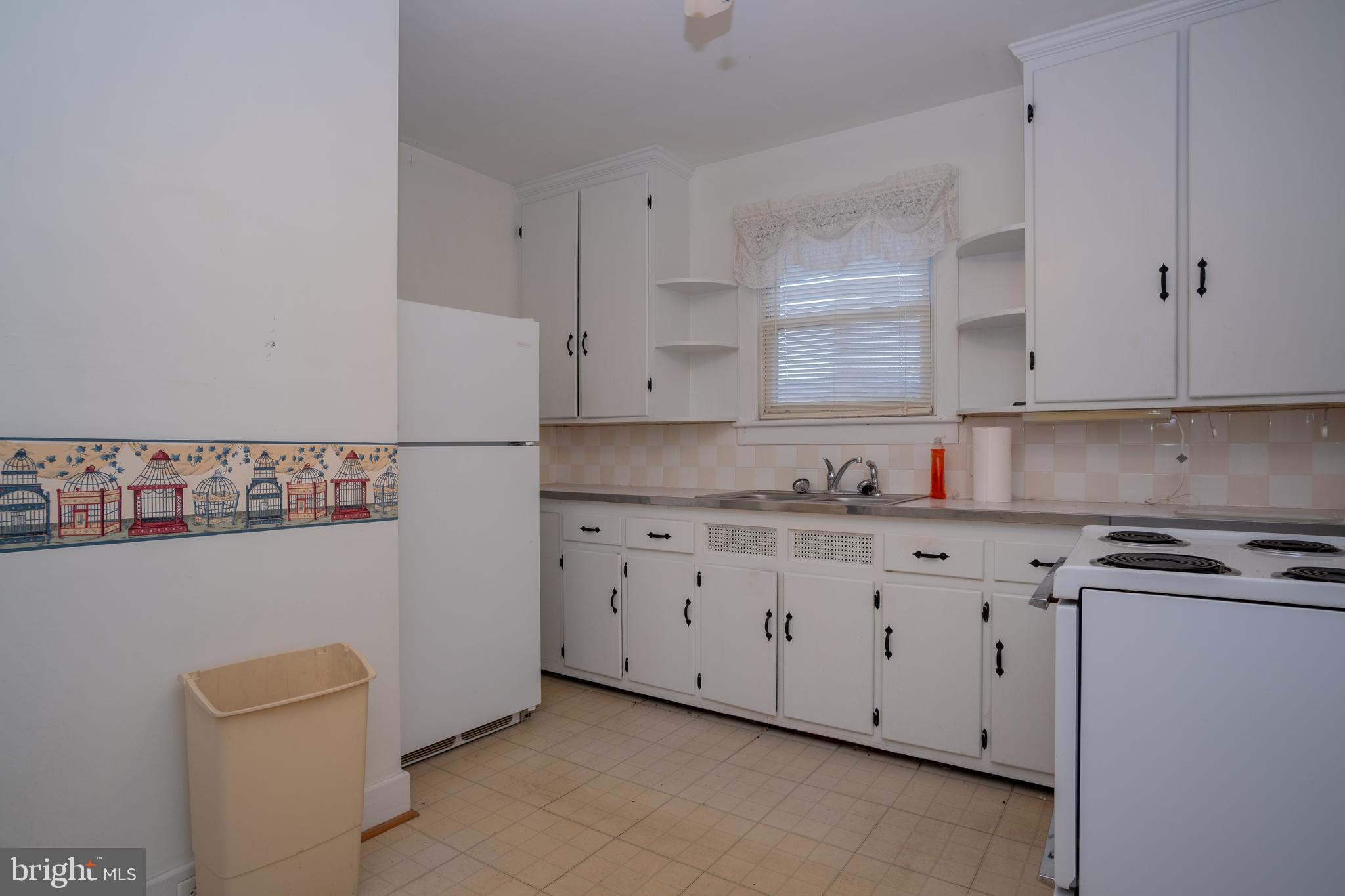 12401 Wright Avenue Cumberland, MD 21502 - Photo 7 of 17 a kitchen with granite countertop white cabinets and a sink