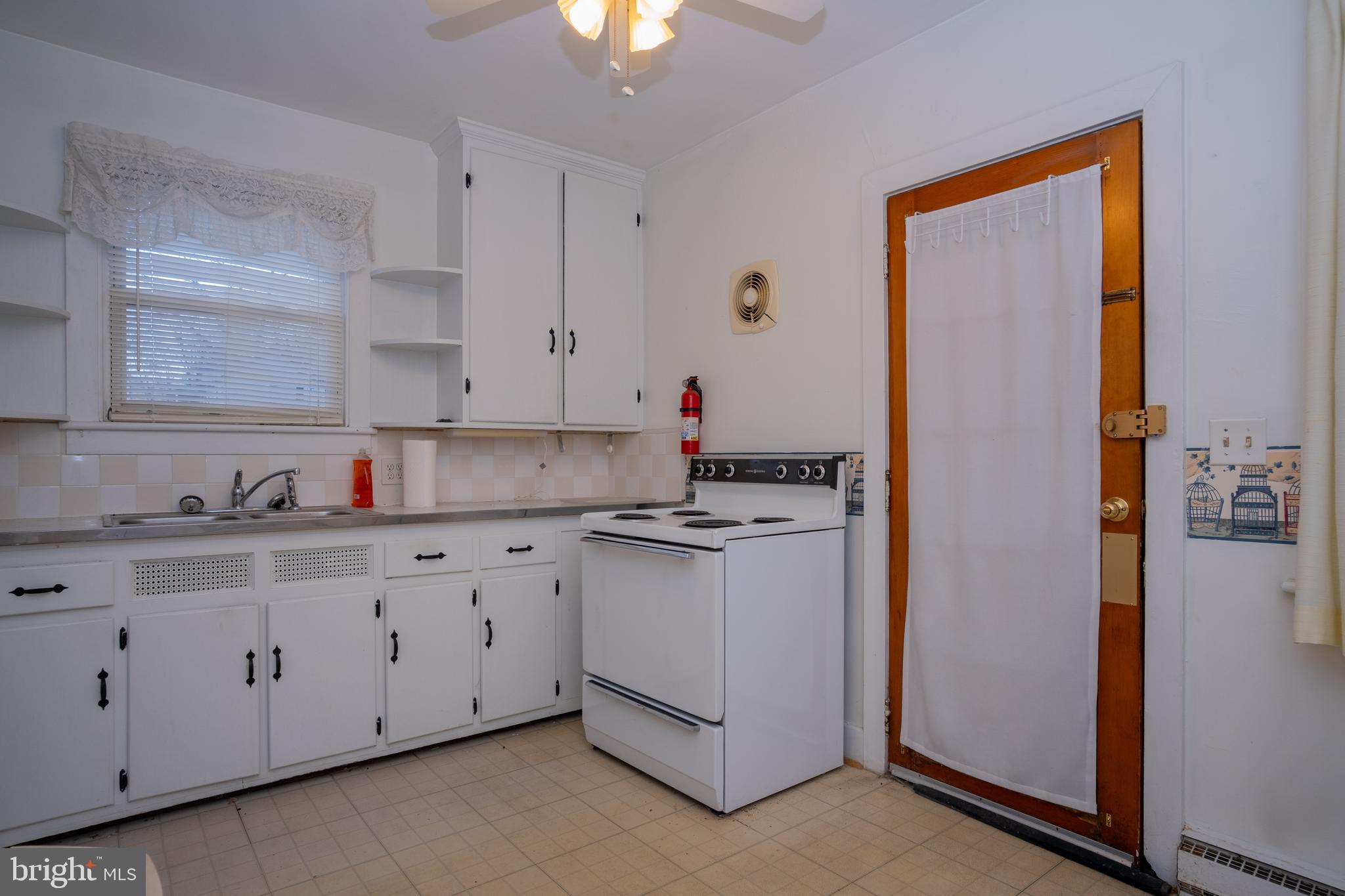 12401 Wright Avenue Cumberland, MD 21502 - Photo 8 of 17 a kitchen with granite countertop white cabinets and white appliances