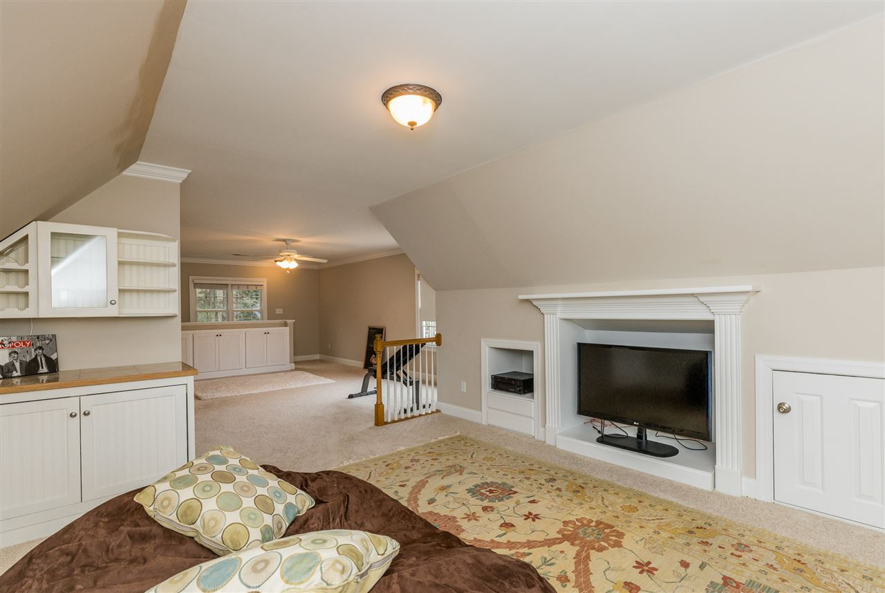 3705 Wesley Ridge Drive Apex, NC 27539 - Photo 21 of 30 Huge bonus room has so much potential. Built-in bar; under eaves storage areas. Bonus Room