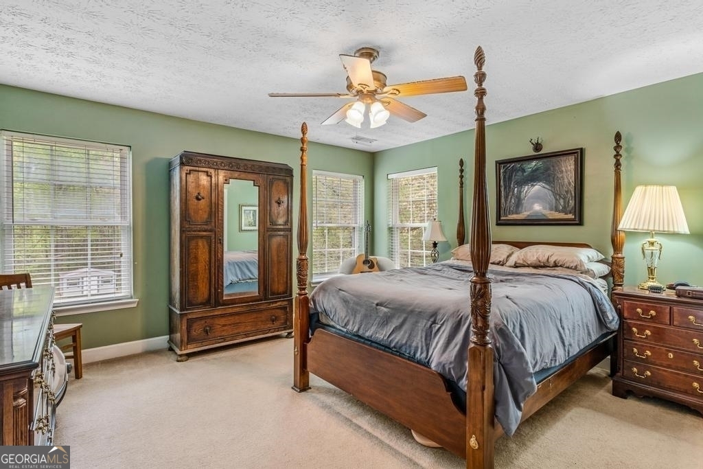 80 Upper Caldwell Road Bowdon, GA 30108 - Photo 13 of 33 a bedroom with a bed mirror and window