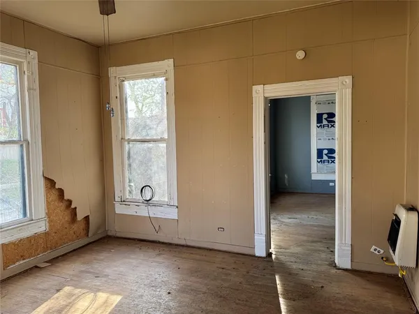 an empty room with windows and closet