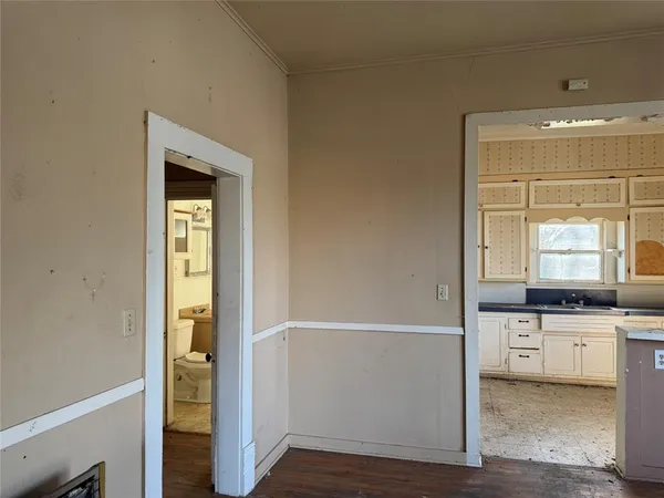 a kitchen with granite countertop a sink and a stove with wooden floor