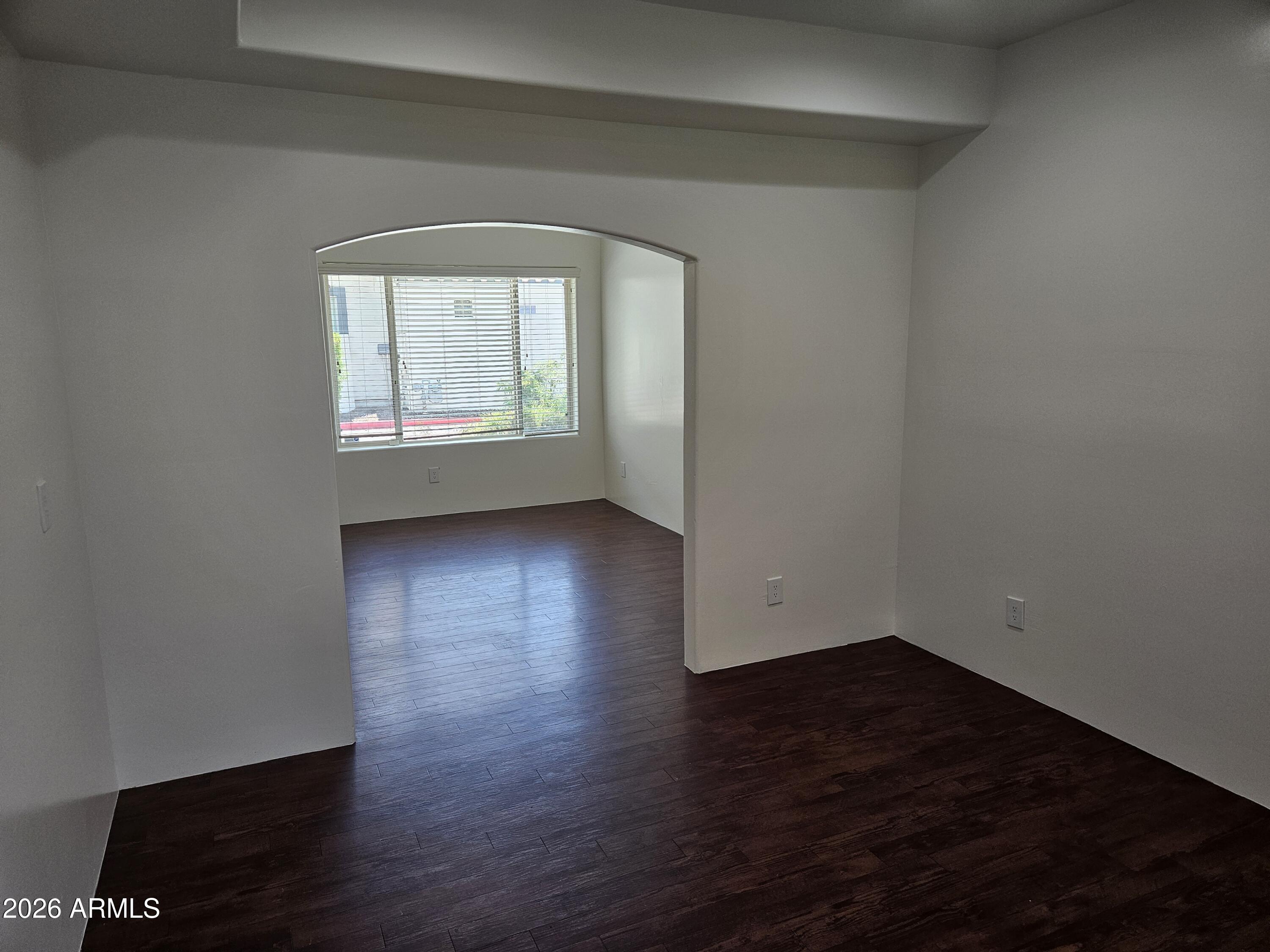 4113 North 22nd Street, Unit 5 Phoenix, AZ 85016 - Photo 12 of 60 an empty room with wooden floor and windows