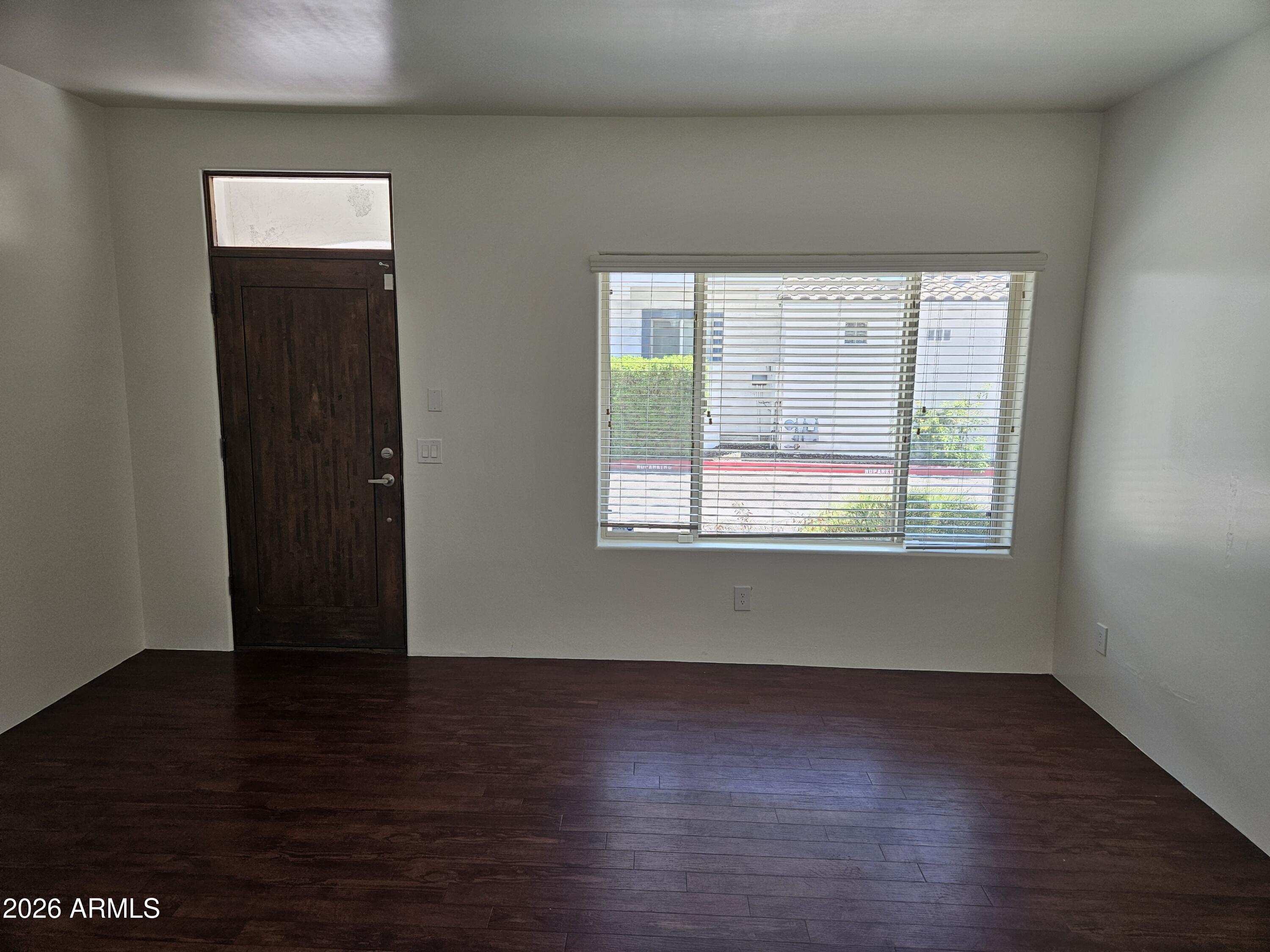 4113 North 22nd Street, Unit 5 Phoenix, AZ 85016 - Photo 13 of 60 an empty room with wooden floor and windows