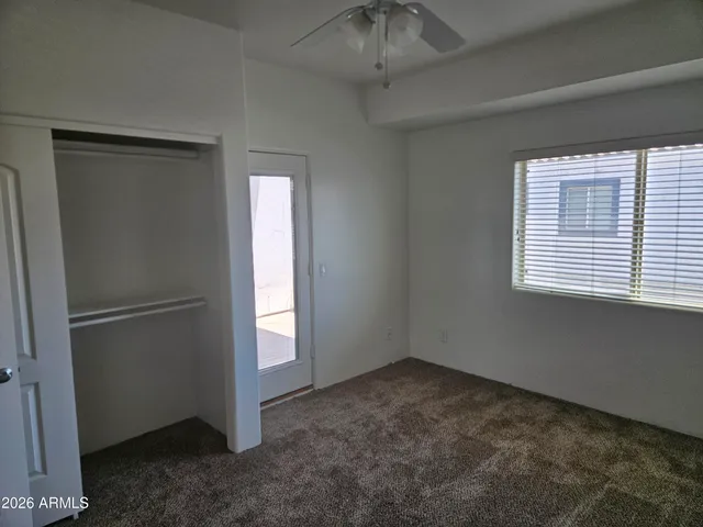 a view of a room that has a door and closet