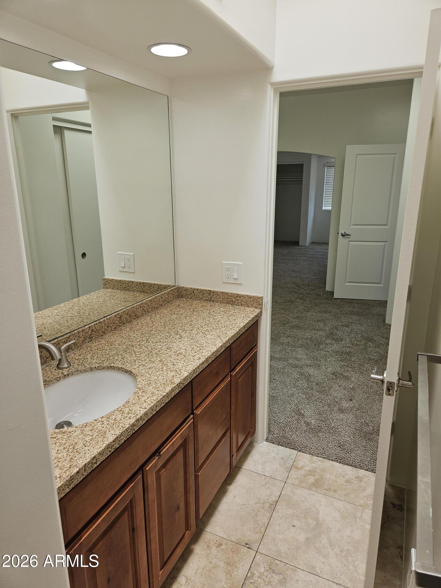 4113 North 22nd Street, Unit 5 Phoenix, AZ 85016 - Photo 46 of 60 a bathroom with a granite countertop sink and a mirror