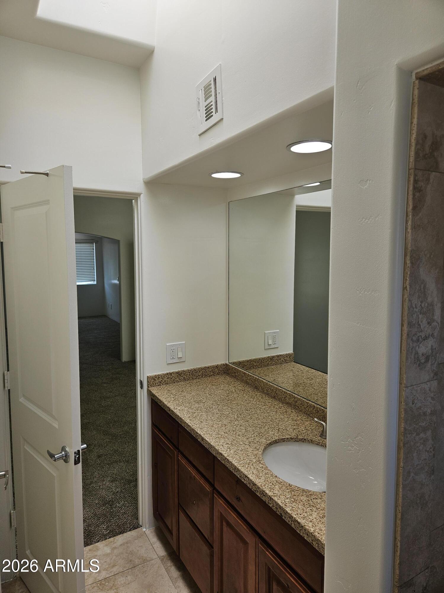 4113 North 22nd Street, Unit 5 Phoenix, AZ 85016 - Photo 50 of 60 a bathroom with a granite countertop sink and a mirror