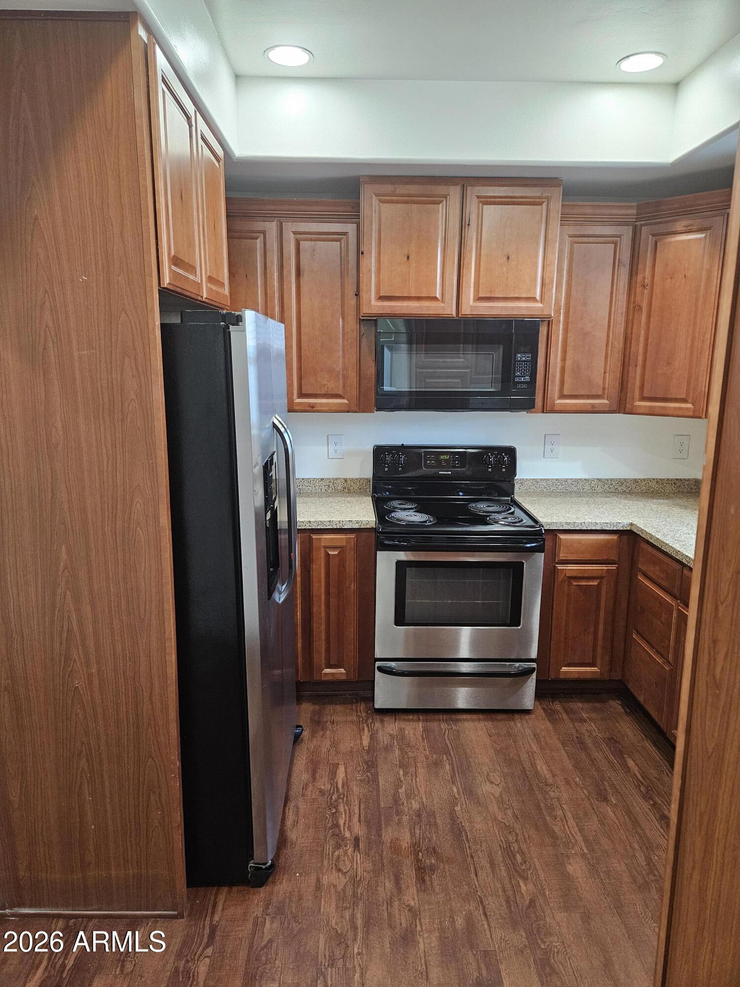 4113 North 22nd Street, Unit 5 Phoenix, AZ 85016 - Photo 7 of 60 a kitchen with granite countertop a refrigerator stove and microwave