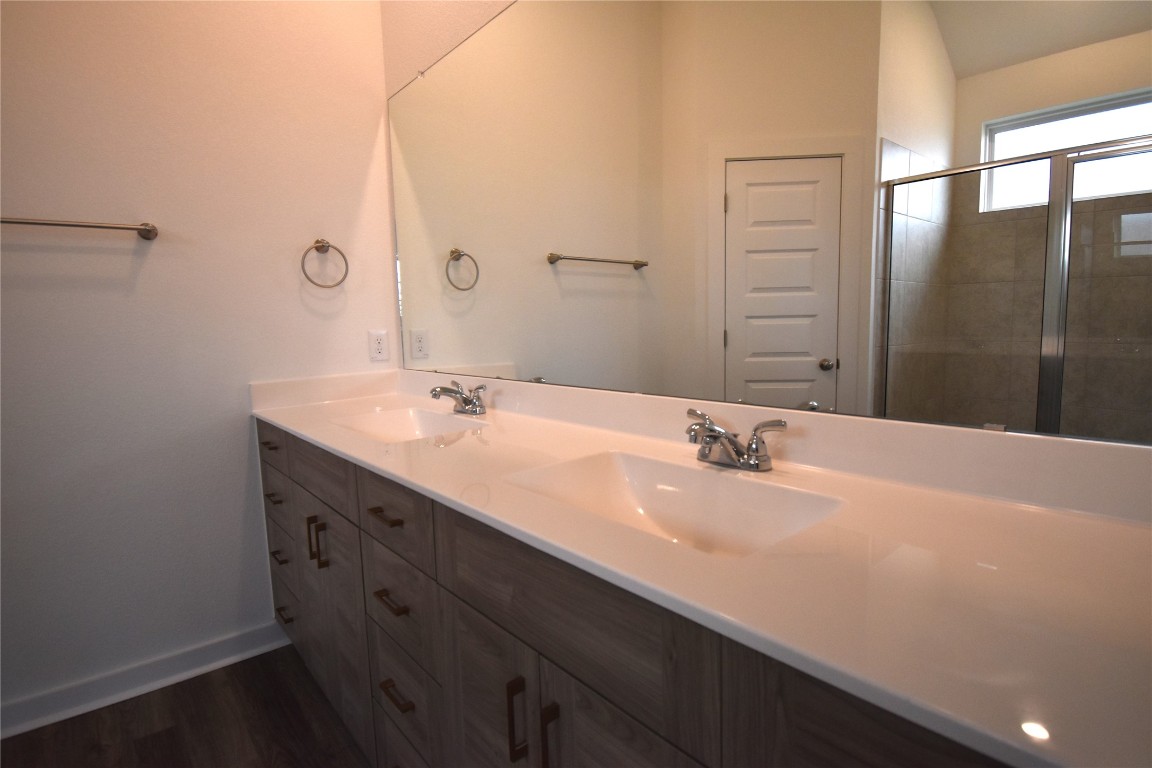18113 Emu Lane Manor, TX 78653 - Photo 12 of 20 a bathroom with a sink and a mirror