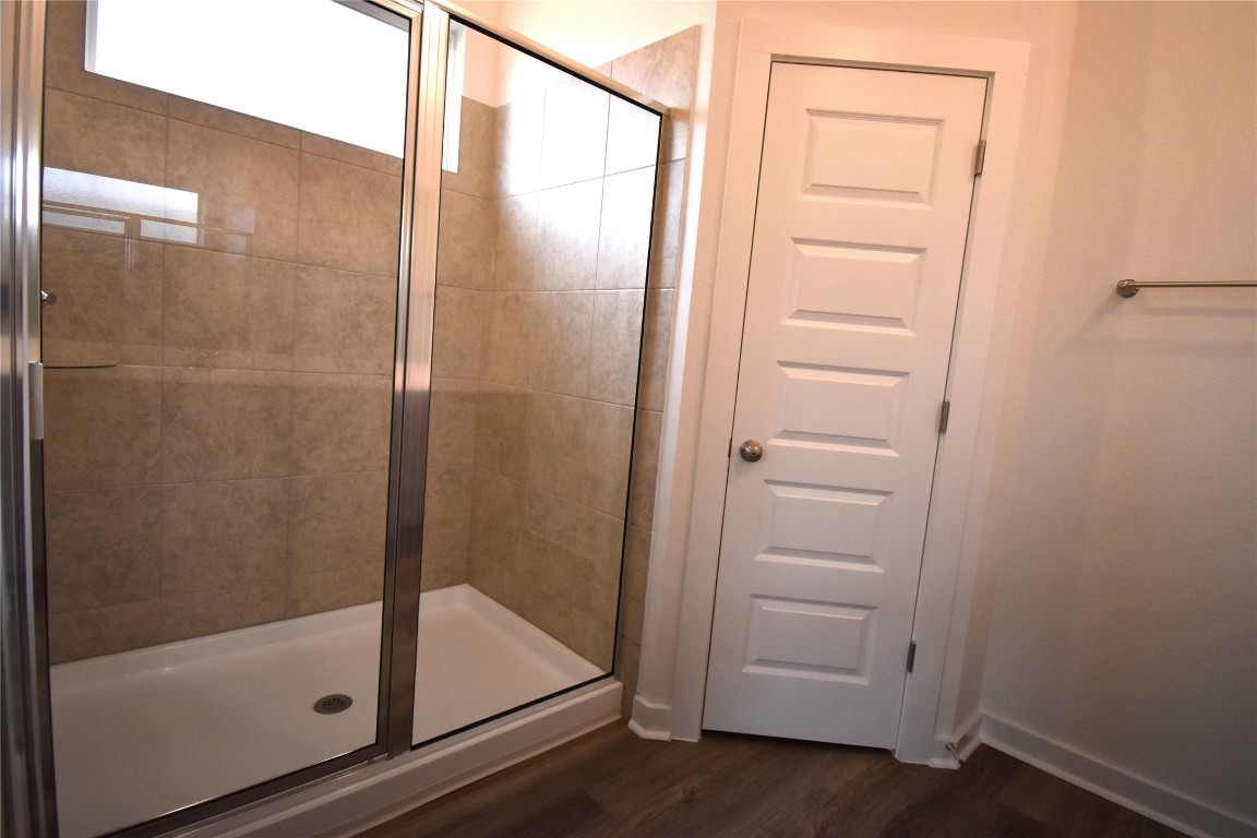 18113 Emu Lane Manor, TX 78653 - Photo 13 of 20 a bathroom with a glass shower door