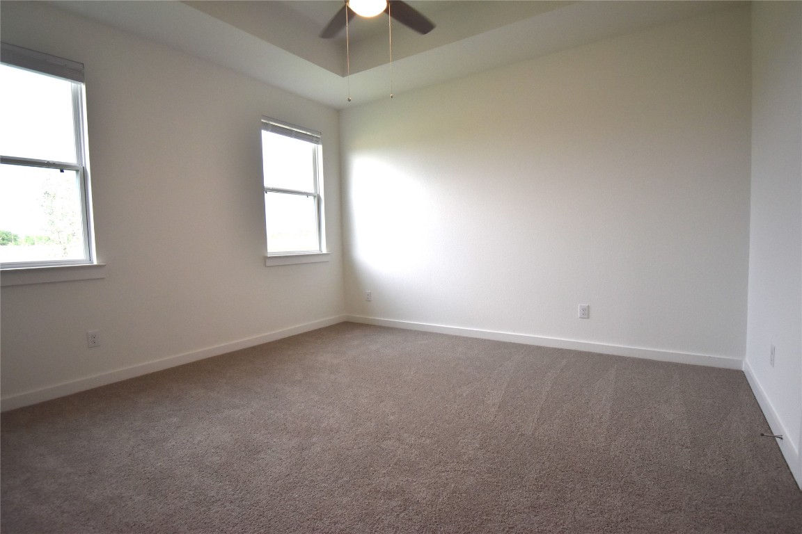 18113 Emu Lane Manor, TX 78653 - Photo 10 of 20 an empty room with a window and a fan