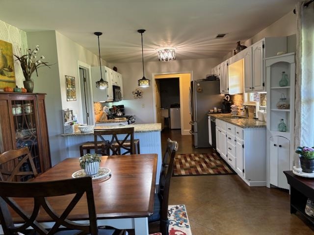 7980 Rankin Branch Road Millington, TN 38053 - Photo 5 of 28 Dining area featuring washer / clothes dryer, a chandelier, and sink