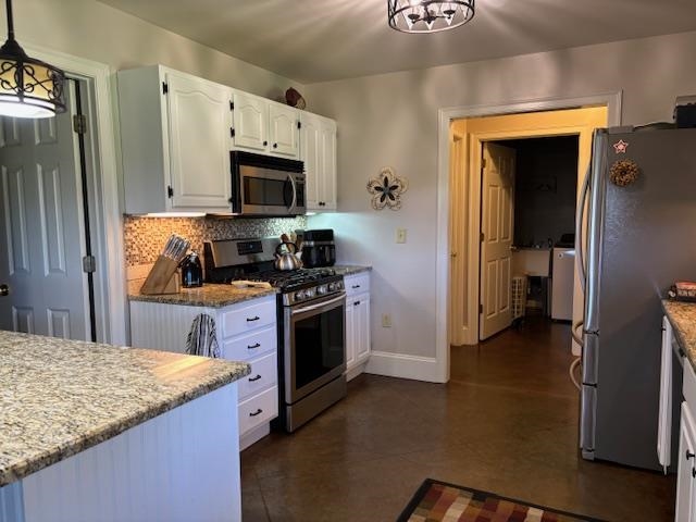 7980 Rankin Branch Road Millington, TN 38053 - Photo 7 of 28 Kitchen with appliances with stainless steel finishes, tasteful backsplash, white cabinets, light stone countertops, and pendant lighting