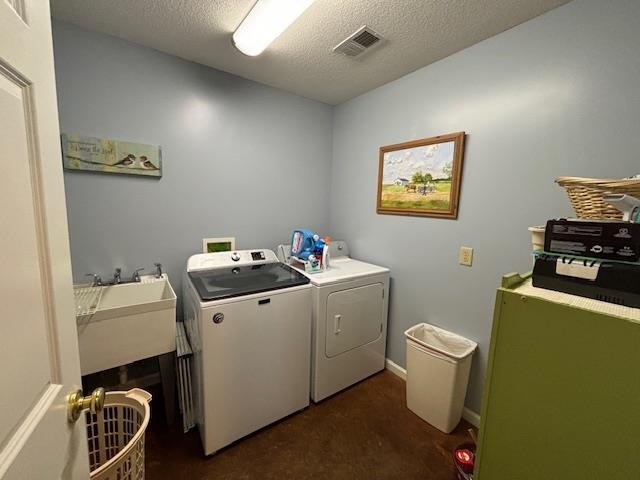 7980 Rankin Branch Road Millington, TN 38053 - Photo 9 of 28 Laundry area featuring a textured ceiling, washer and clothes dryer, sink, and dark carpet