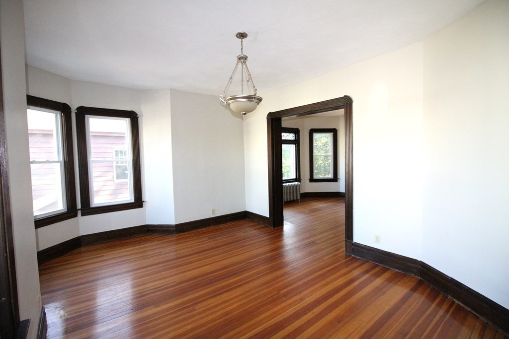 524 Armory Street Springfield, MA 01104 - Photo 5 of 11 a view of a room with wooden floor and windows