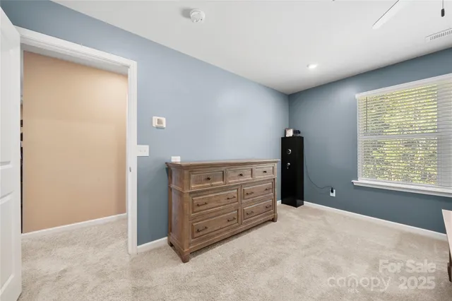 a view of room with cabinet and mirror